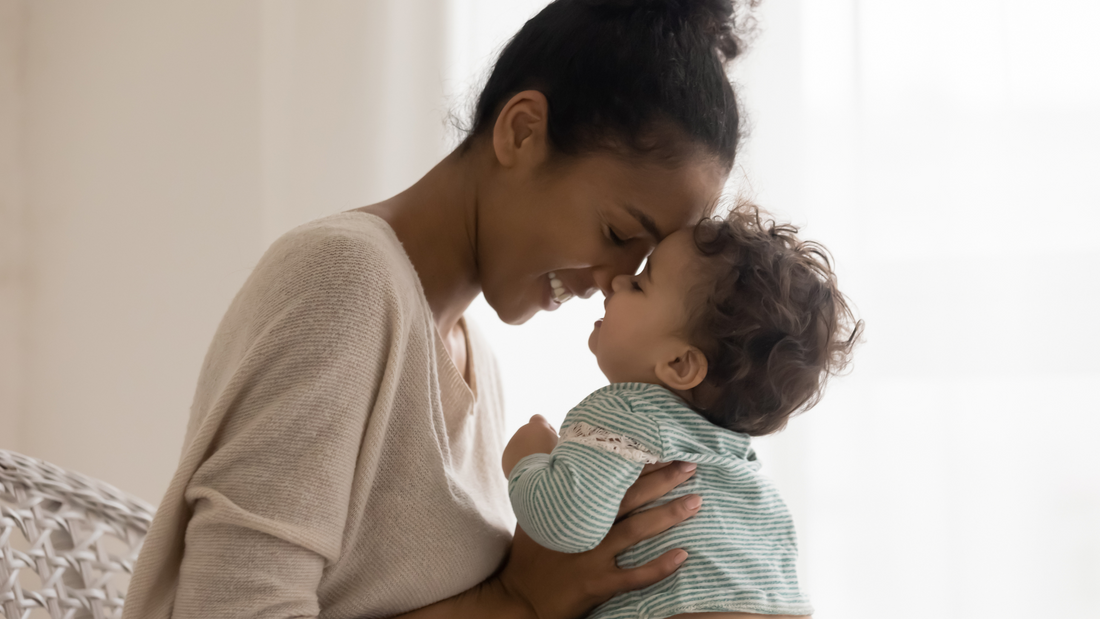 mom holding baby with faces touching