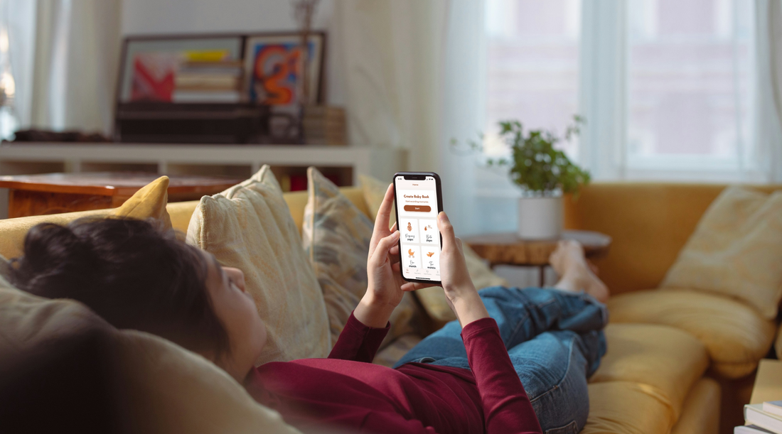 mom laying on couch and recording memories on baby memory book app
