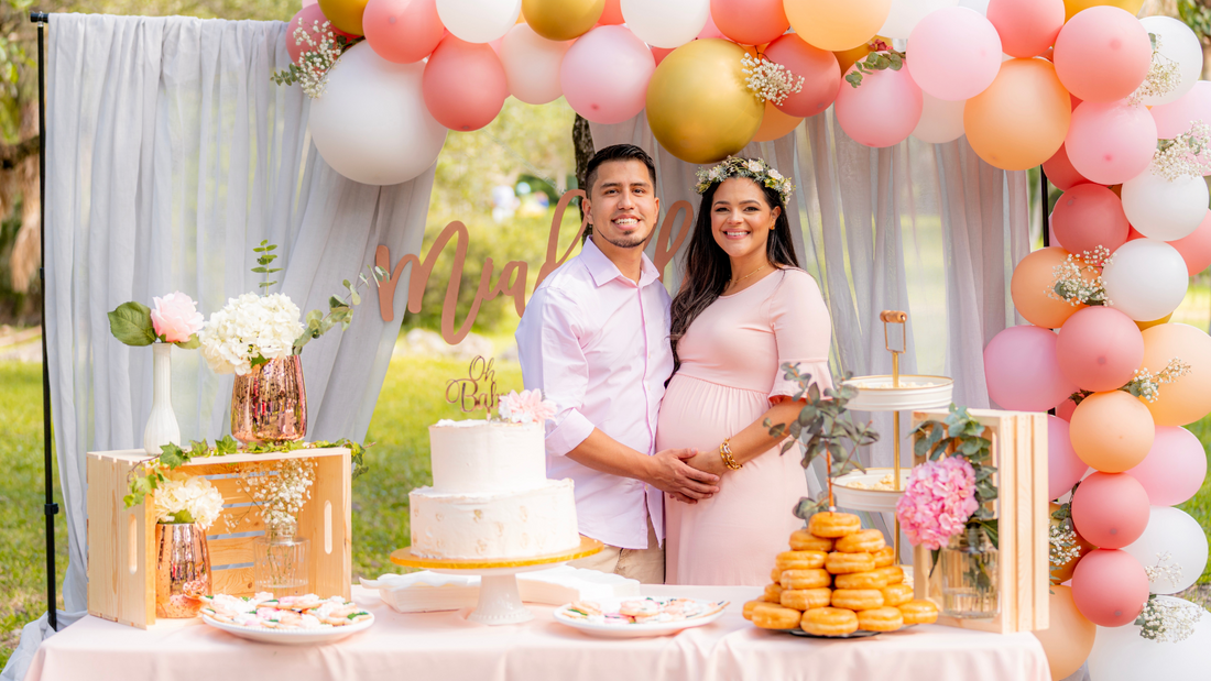 husband and wife holding hands at baby shower