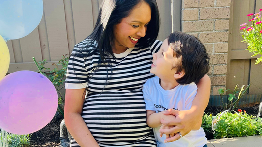 pregnant mum hugging first born