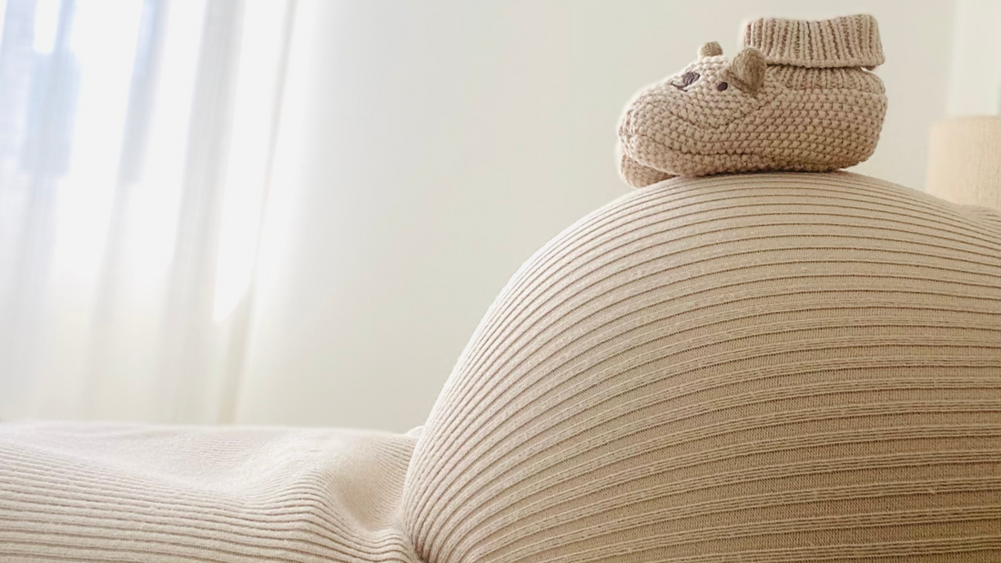 baby bump with baby shoes