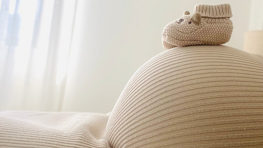 baby bump with baby shoes