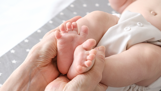 mum holding baby's feet