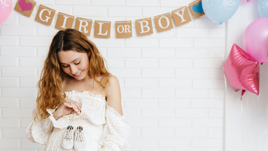 pregnant lady at gender reveal with girl or boy sign
