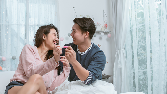 couple reading pregnancy test and excited about journey ahead