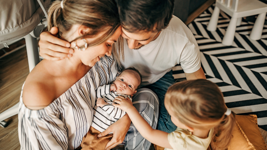 family holding newborn and brother meeting sibling for first time