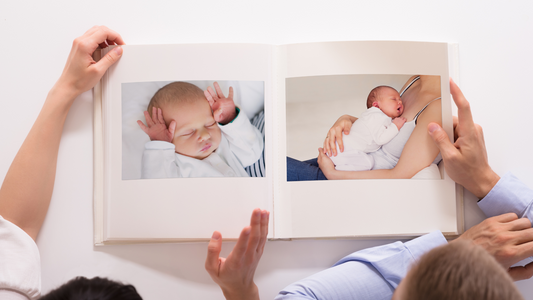 couple flipping pages in baby book album