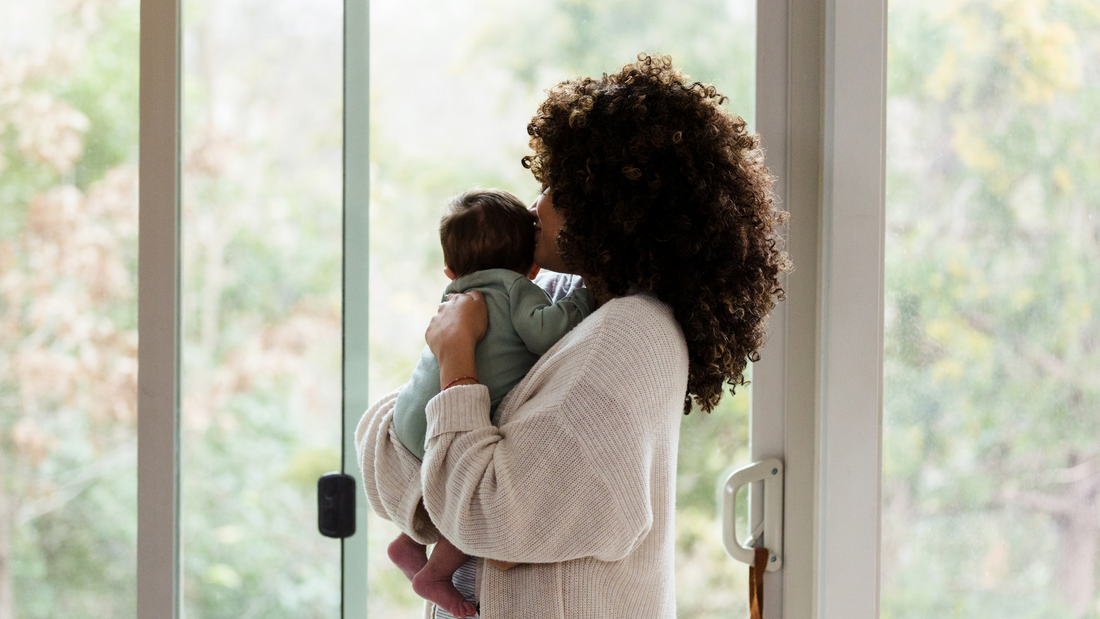 mom holding newborn baby in arms