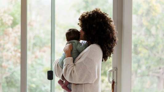 mom holding newborn baby in arms