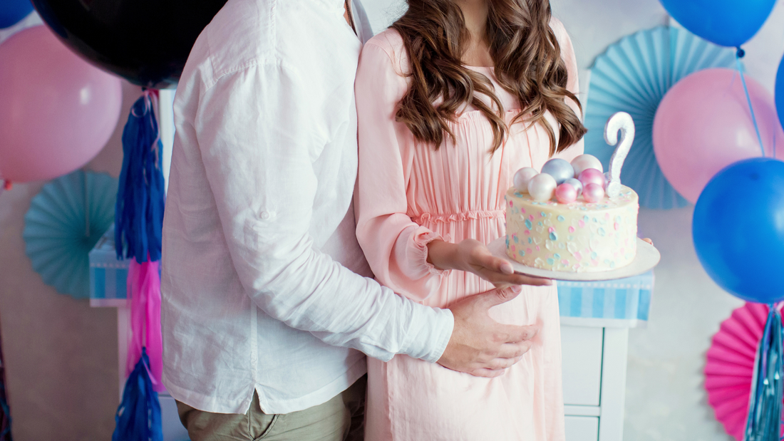 expecting parents holding gender reveal cake
